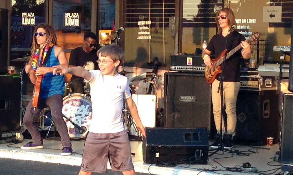 The Crazy Carls jam for craft beer festival-goers while a young fan entertains the crowd.