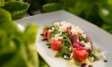 Watermelon salad with pickled onions, BW Farm baby arugula, feta cheese and balsamic reduction featured at Florida Fresh Outdoor Kitchen.