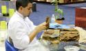 Watch craftsmen at work rolling cigars. 